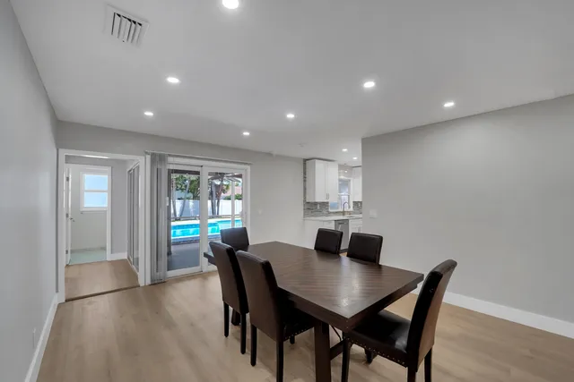 a view of a dining room with furniture and window