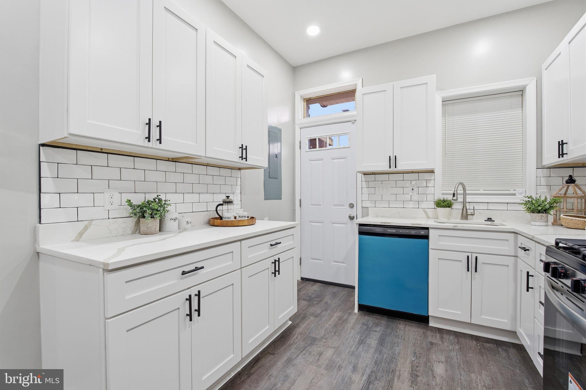 1708 Federal Street Baltimore, MD 21213 - Photo 12 of 33 a kitchen with white cabinets stainless steel appliances and sink