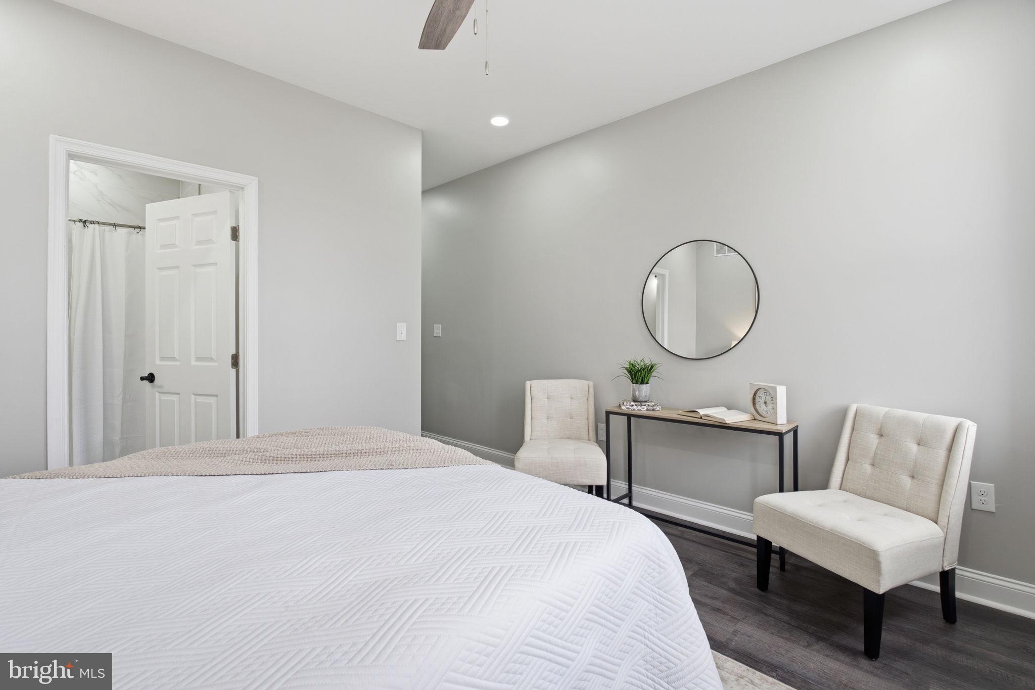 1708 Federal Street Baltimore, MD 21213 - Photo 16 of 33 a bedroom with a bed mirror and a table