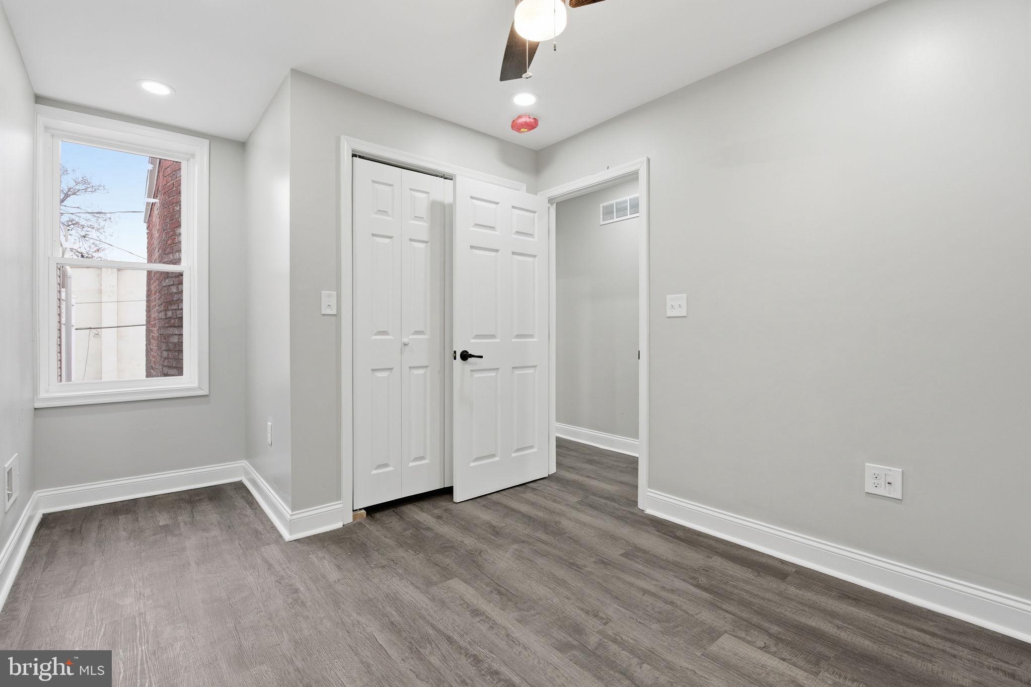 1708 Federal Street Baltimore, MD 21213 - Photo 20 of 33 wooden floor in an empty room with a window