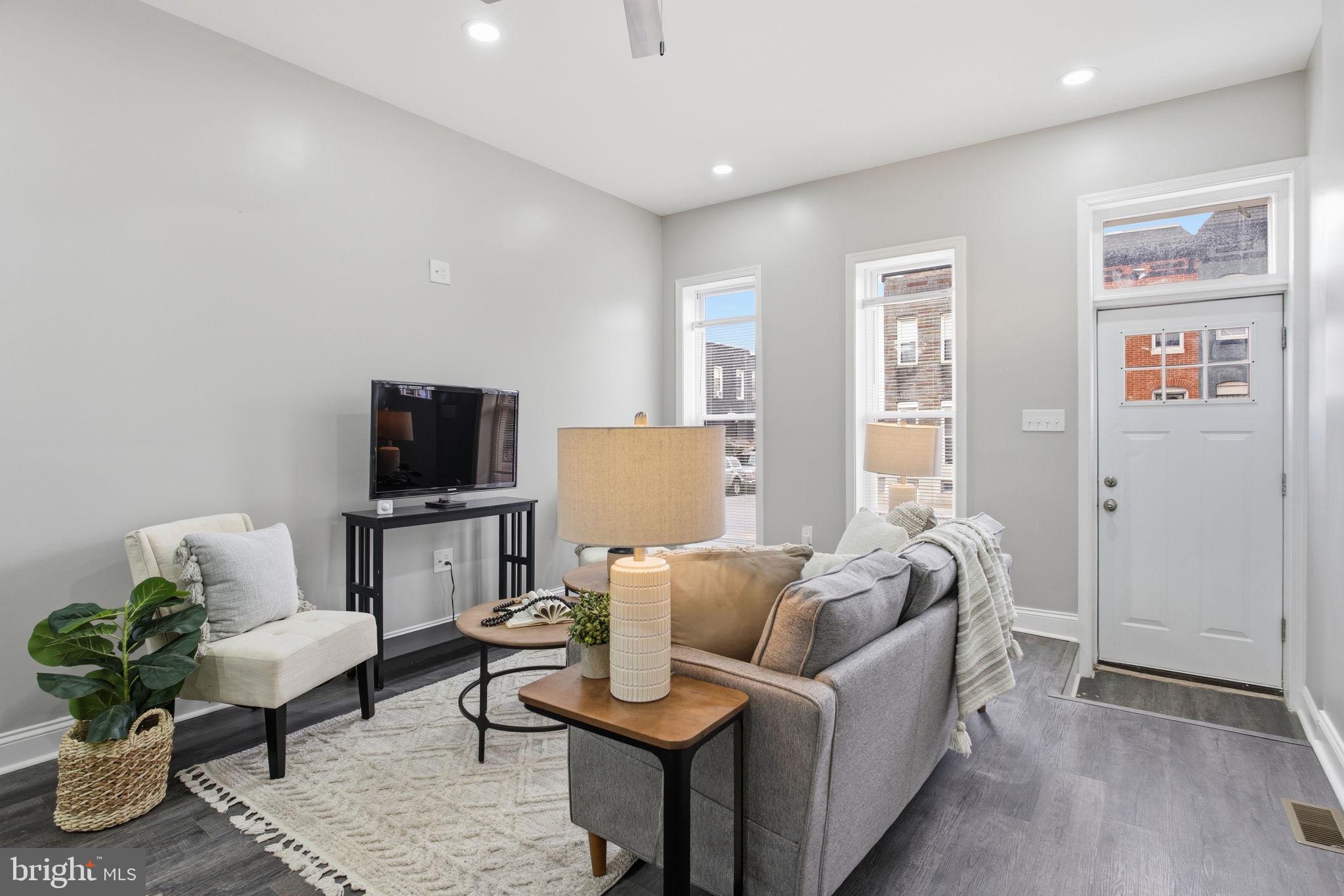 1708 Federal Street Baltimore, MD 21213 - Photo 2 of 33 a living room with furniture and a flat screen tv