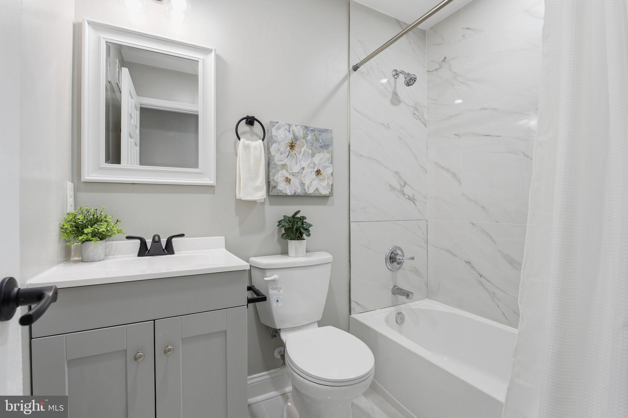1708 Federal Street Baltimore, MD 21213 - Photo 25 of 33 a bathroom with a sink a toilet and bathtub