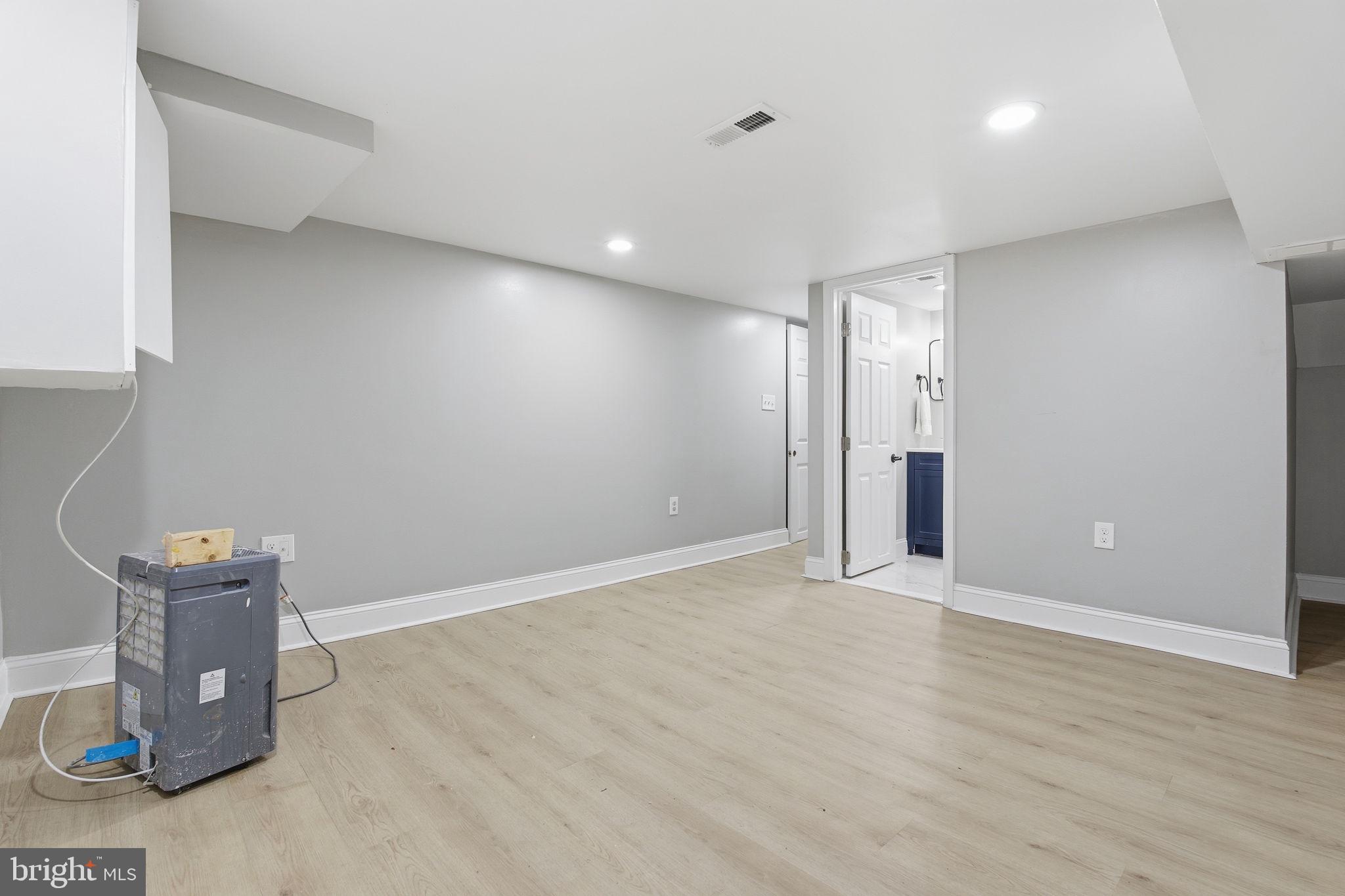 1708 Federal Street Baltimore, MD 21213 - Photo 27 of 33 a view of an empty room with wooden floor and a cabinet