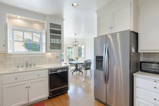 a kitchen with a refrigerator and a sink