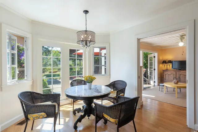 a view of a dining room with furniture wooden floor and chandelier