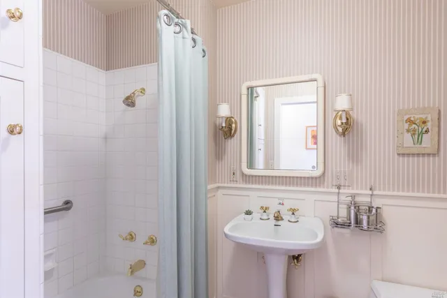 a bathroom with a sink a mirror and a shower