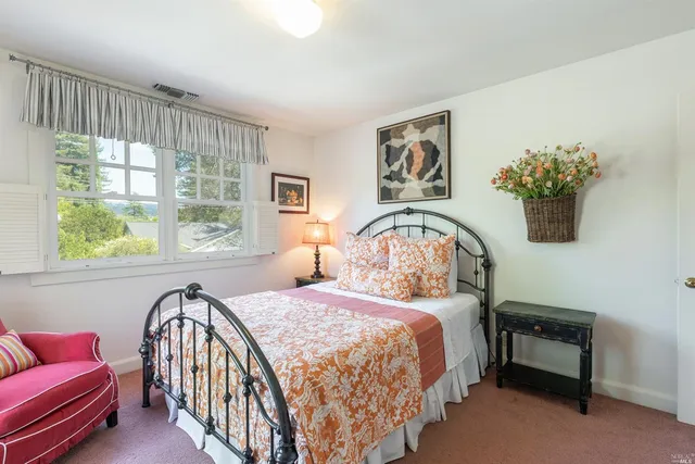 a bedroom with a bed and a couch