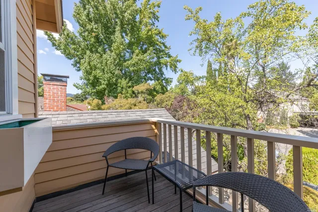 a view of balcony with wooden floor and seating space
