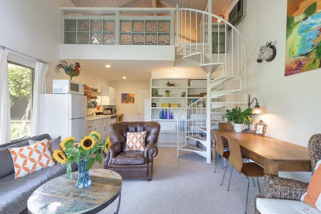 a living room with furniture and flowers