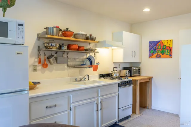 a utility room with cabinets washer and dryer