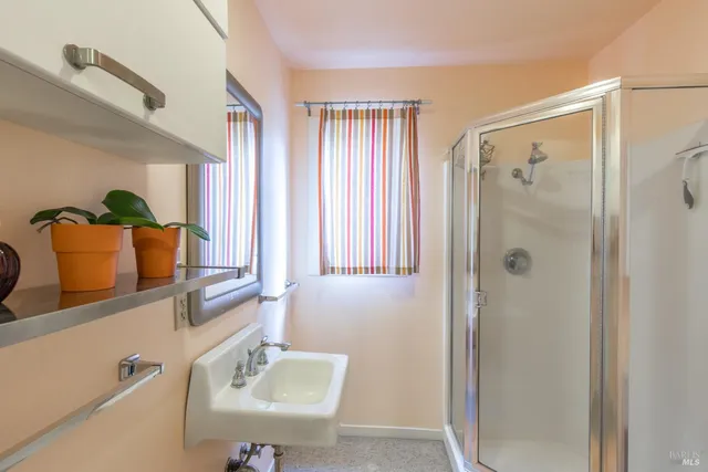 a bathroom with a shower and a sink