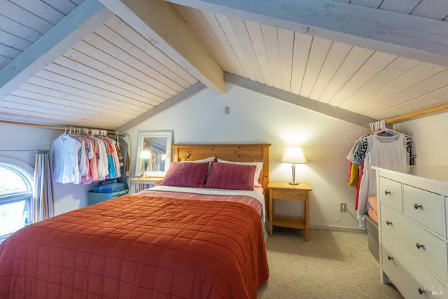 a bed sitting in a bedroom next to a window