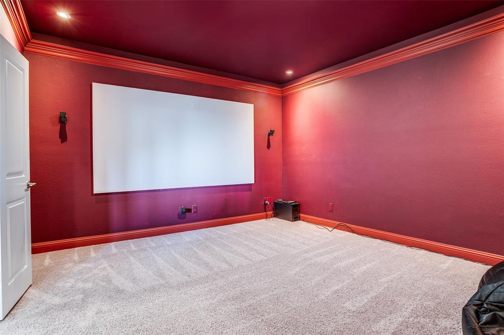 16380 Radstock Road Frisco, TX 75033 - Photo 18 of 39 Carpeted home theater room with crown molding and recessed lighting