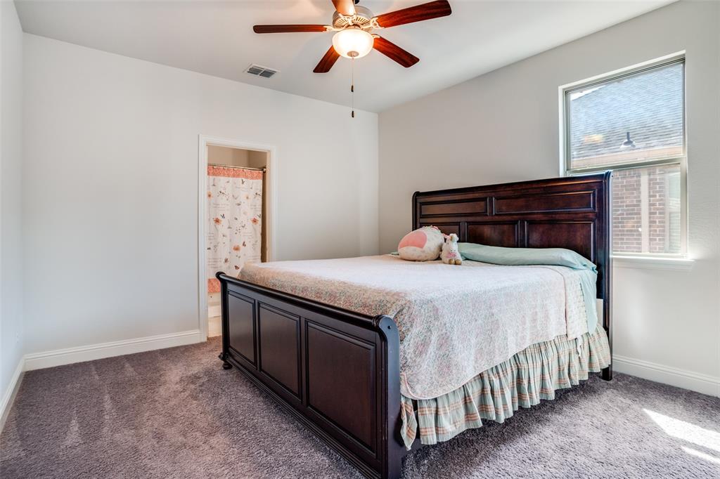 16380 Radstock Road Frisco, TX 75033 - Photo 19 of 39 Bedroom featuring a ceiling fan, light carpet, and ensuite bath