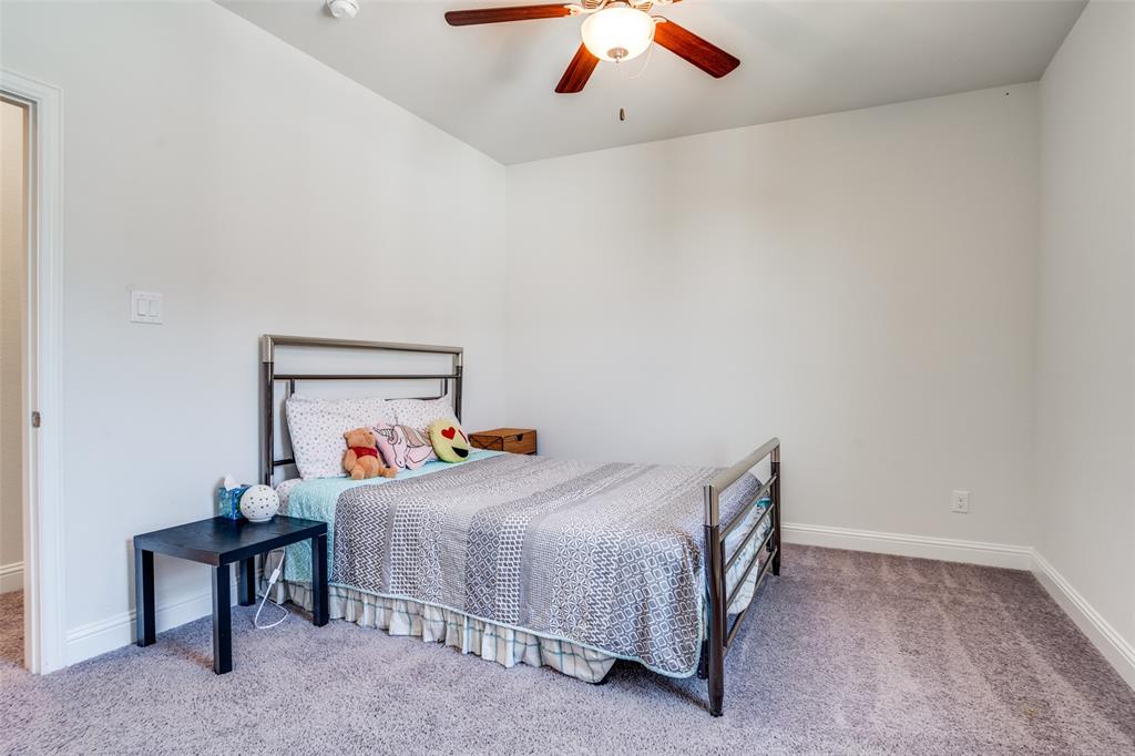 16380 Radstock Road Frisco, TX 75033 - Photo 22 of 39 Bedroom with light colored carpet and a ceiling fan