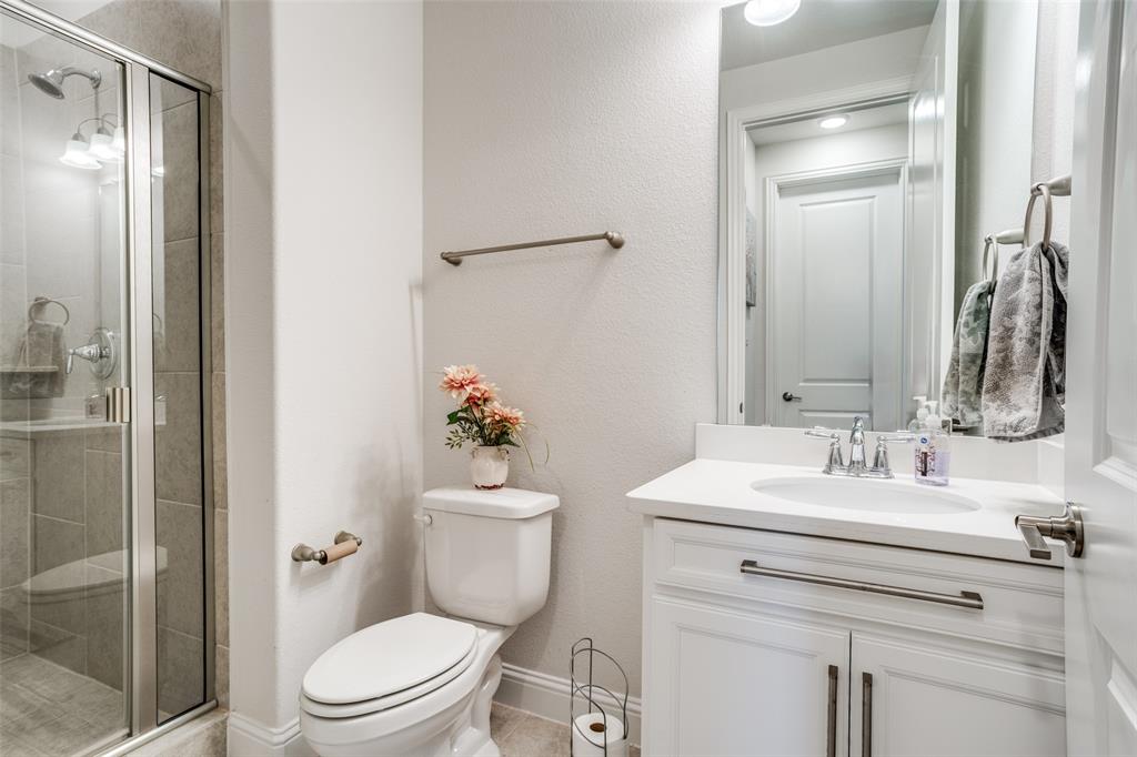 16380 Radstock Road Frisco, TX 75033 - Photo 24 of 39 Full bathroom with vanity, a stall shower, and a textured wall