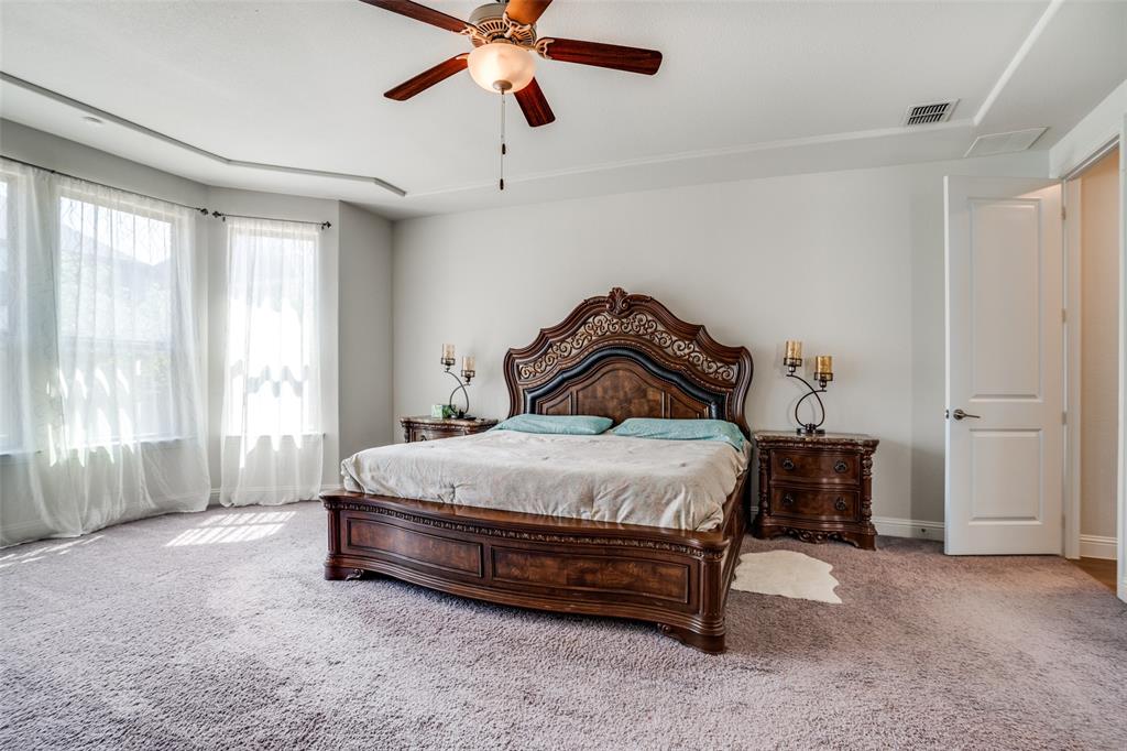 16380 Radstock Road Frisco, TX 75033 - Photo 25 of 39 Carpeted bedroom with ceiling fan and baseboards