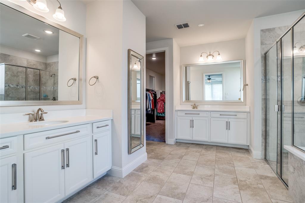 16380 Radstock Road Frisco, TX 75033 - Photo 27 of 39 Full bath with a stall shower, two vanities, and a spacious closet