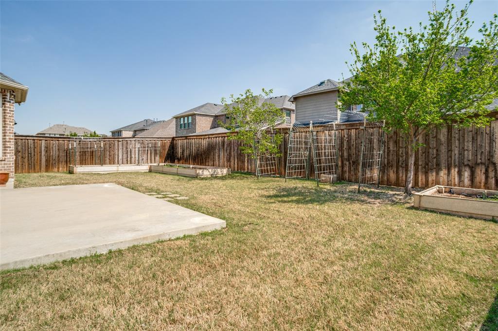 16380 Radstock Road Frisco, TX 75033 - Photo 34 of 39 Fenced backyard with a vegetable garden and a patio area