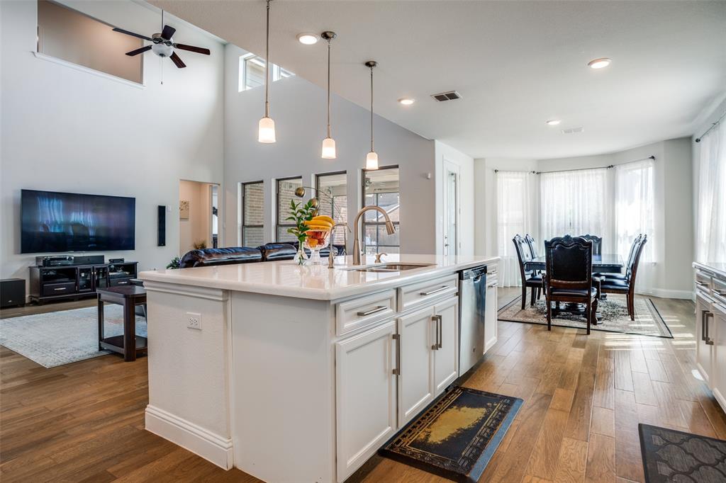 16380 Radstock Road Frisco, TX 75033 - Photo 37 of 39 Kitchen featuring open floor plan, an island with sink, white cabinets, dark wood-style flooring, and a ceiling fan