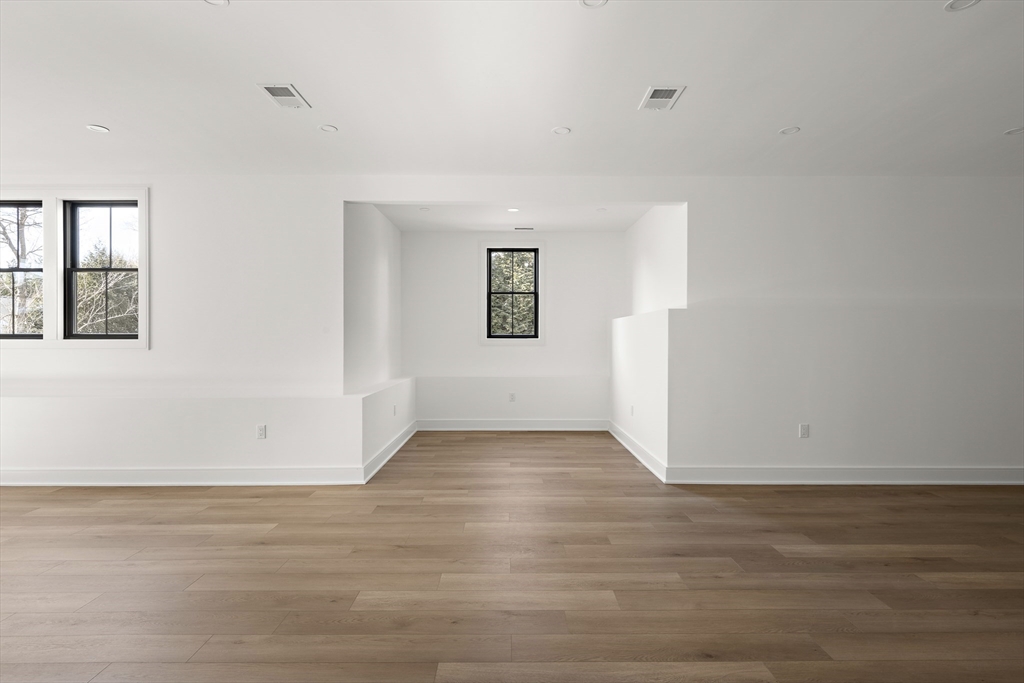 42 Thornton Road Needham, MA 02492 - Photo 36 of 38 a view of an empty room with wooden floor and a window