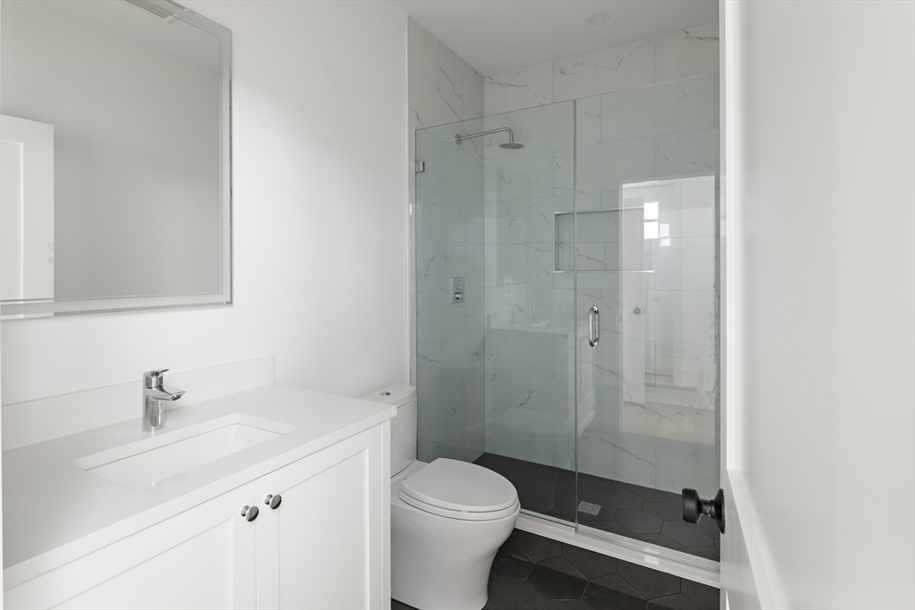 42 Thornton Road Needham, MA 02492 - Photo 37 of 38 a bathroom with a sink toilet and shower