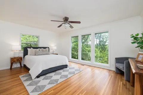 a view of a hallway with wooden floor and entryway