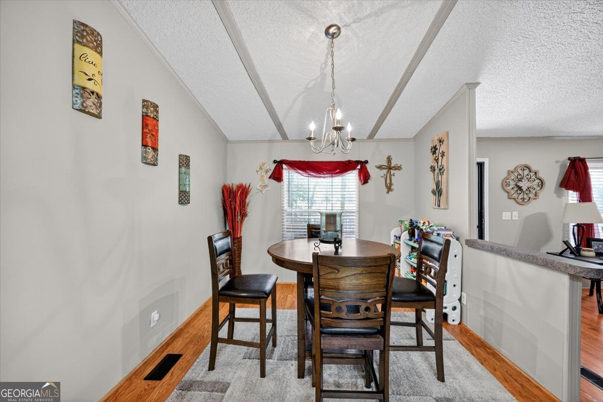1659 Henderson Road Macon, GA 31217 - Photo 13 of 44 a view of a dining room with furniture and a chandelier