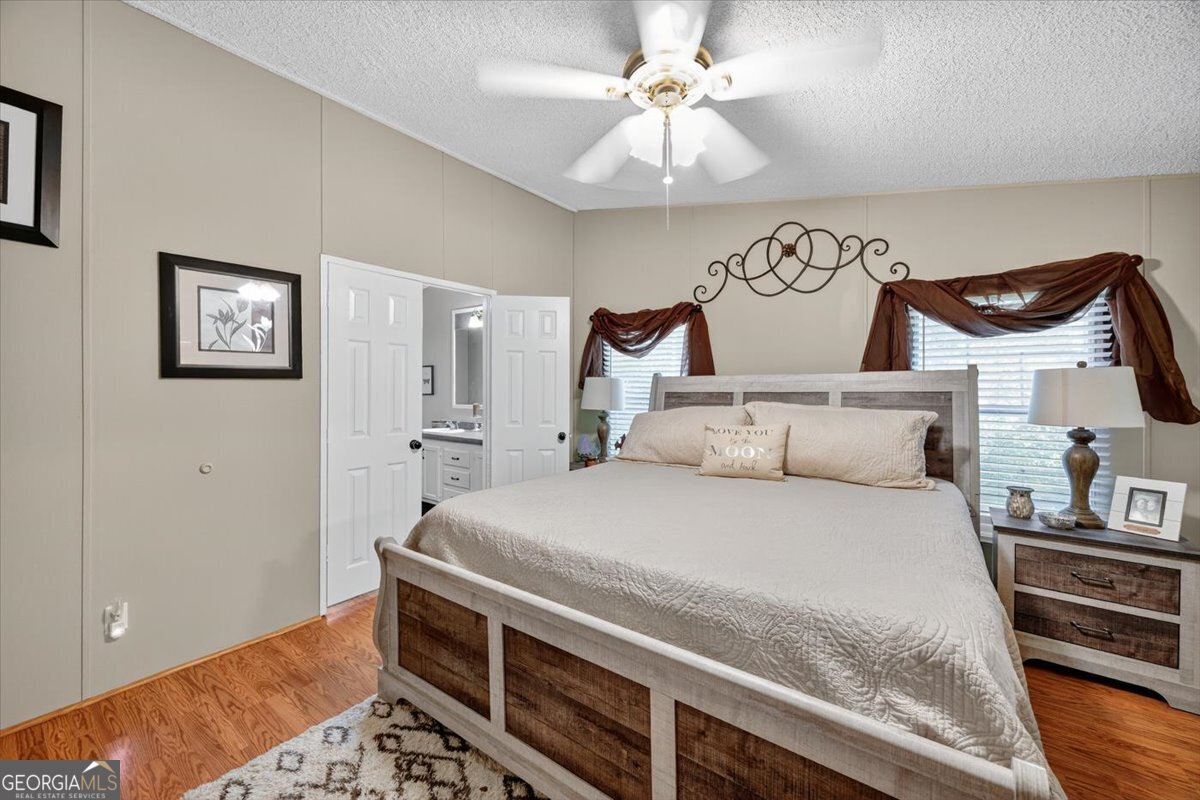 1659 Henderson Road Macon, GA 31217 - Photo 16 of 44 a bedroom with a bed and a chandelier