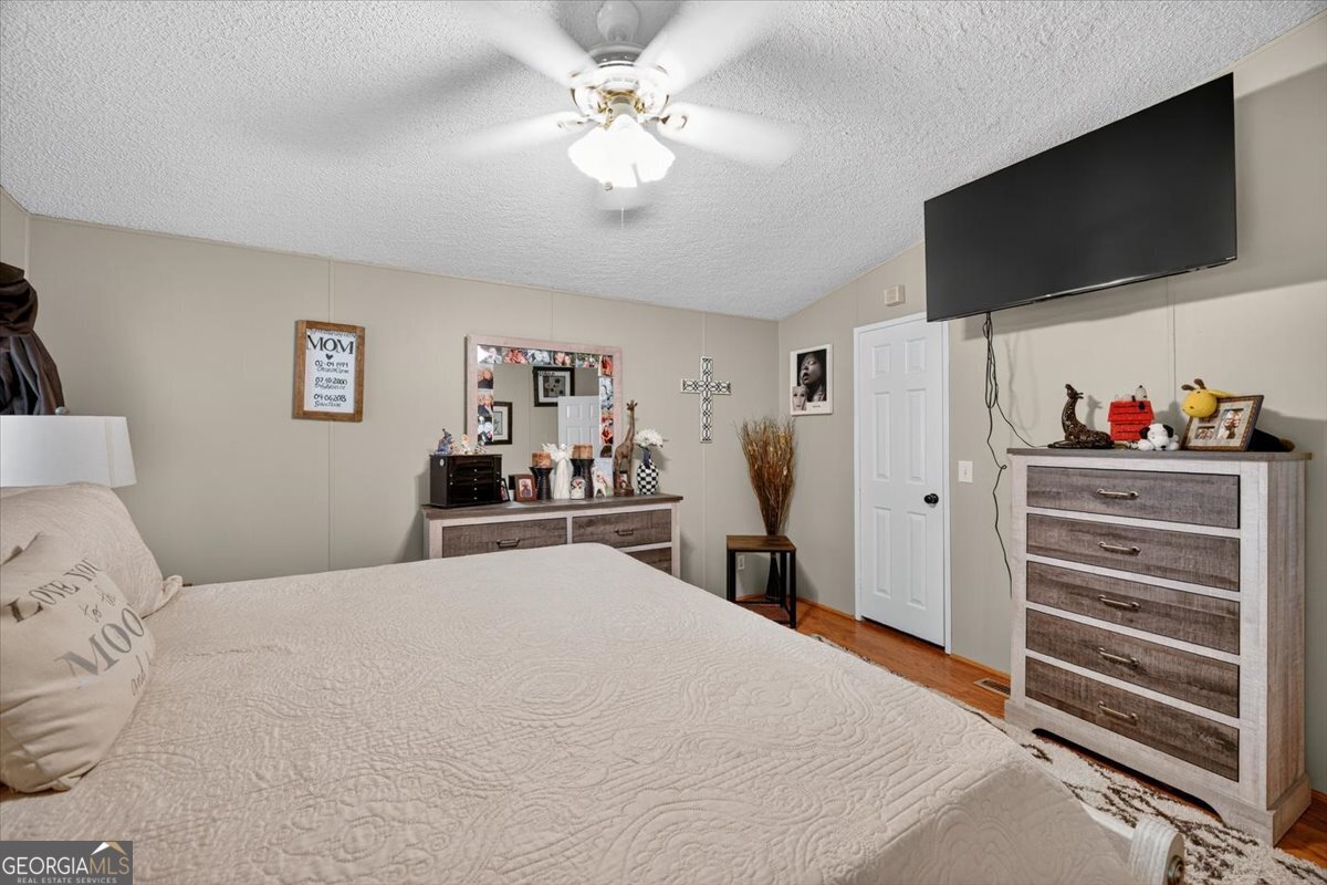 1659 Henderson Road Macon, GA 31217 - Photo 17 of 44 a bedroom with a bed and a flat screen tv