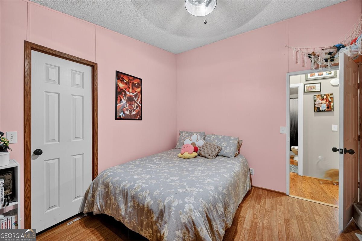 1659 Henderson Road Macon, GA 31217 - Photo 22 of 44 a bedroom with a bed and a view of bathroom