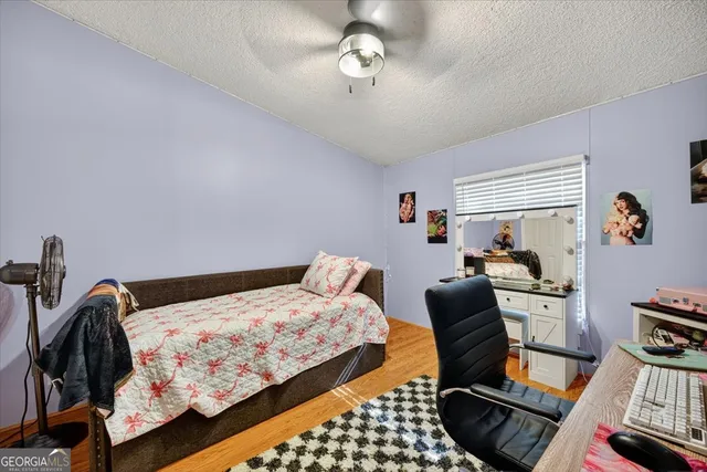 a bedroom with bed and a chandelier