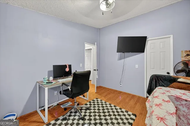 a bedroom with a bed and flat screen tv