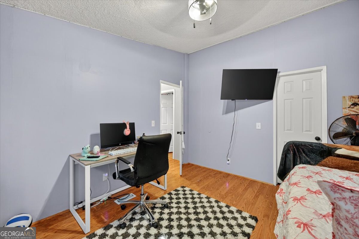 1659 Henderson Road Macon, GA 31217 - Photo 25 of 44 a bedroom with a bed and flat screen tv