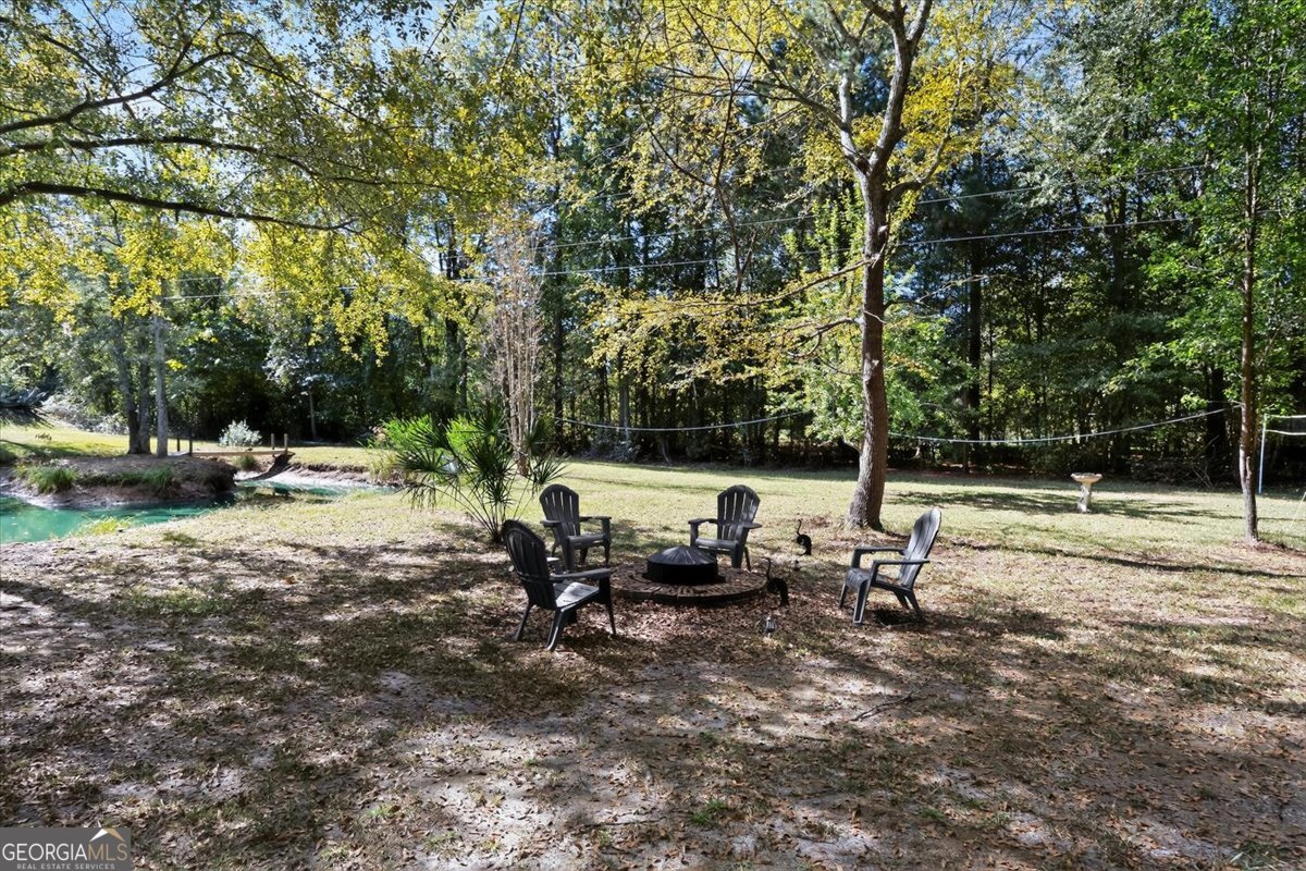 1659 Henderson Road Macon, GA 31217 - Photo 40 of 44 a view of backyard with swimming pool and trees