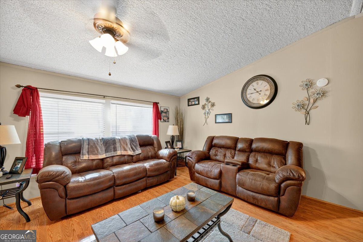 1659 Henderson Road Macon, GA 31217 - Photo 4 of 44 a living room with furniture a clock and a window