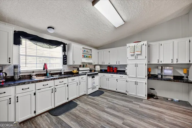 a kitchen with sink cabinets and window