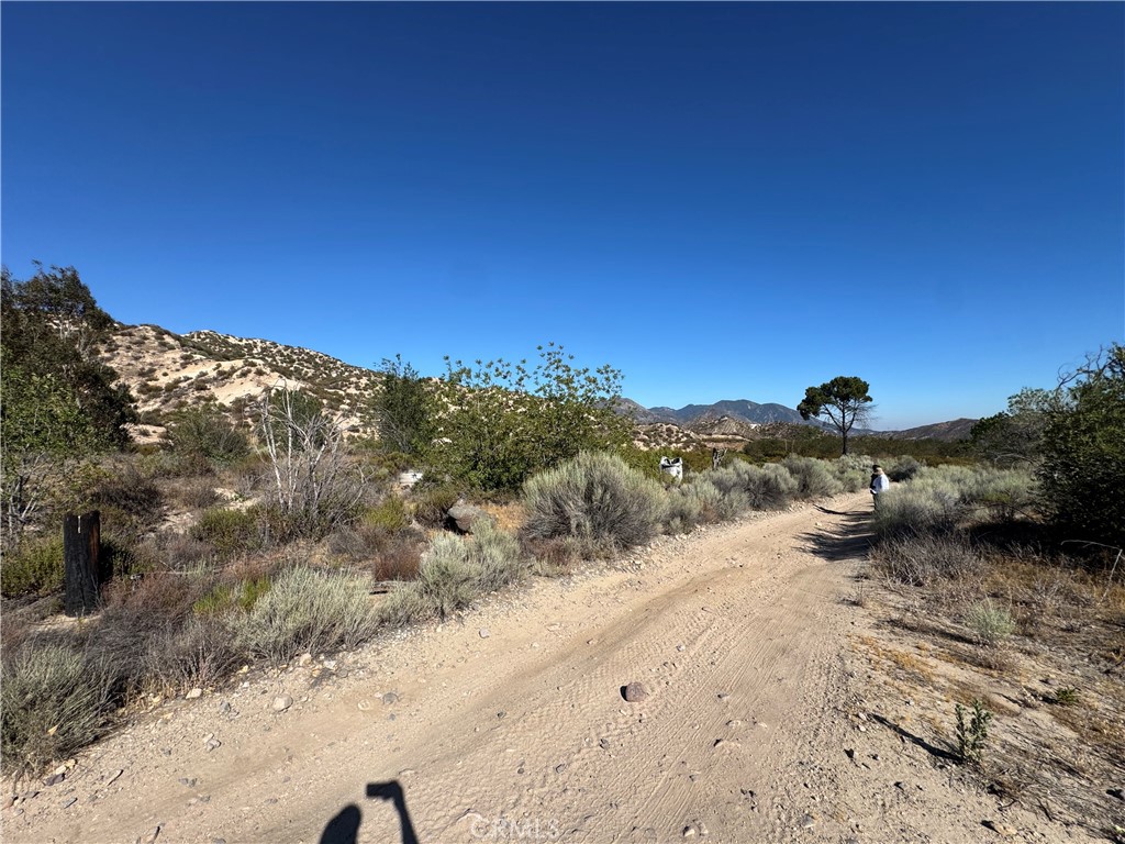 4292 Davis Ranch Road Phelan, CA 92371 - Photo 2 of 50 a view of a road with a mountain in the background