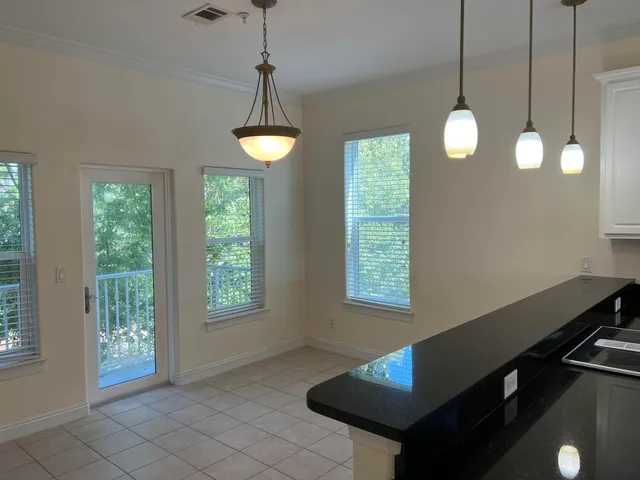 a view of an empty room with windows and