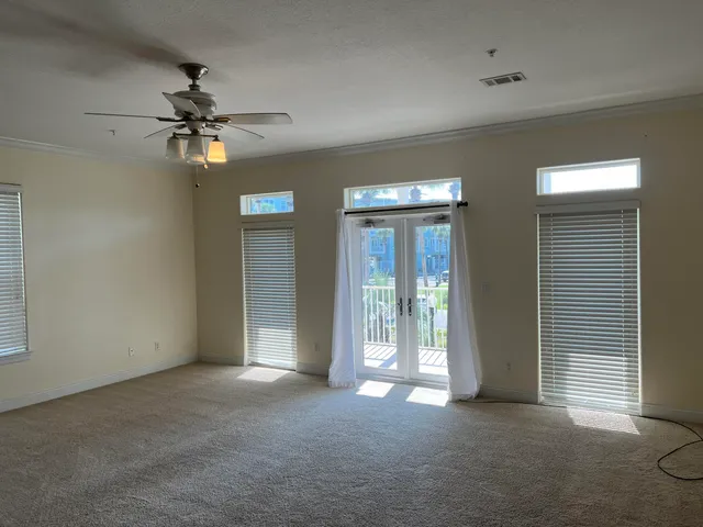 a view of a livingroom with a ceiling fan and window