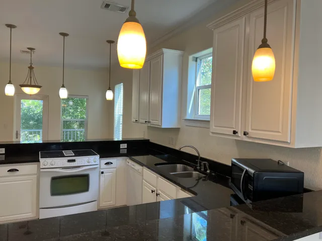 a kitchen that has a sink and a stove