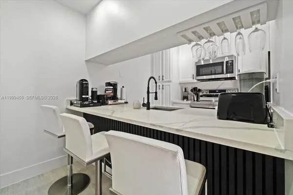 a kitchen with stainless steel appliances a sink and a refrigerator