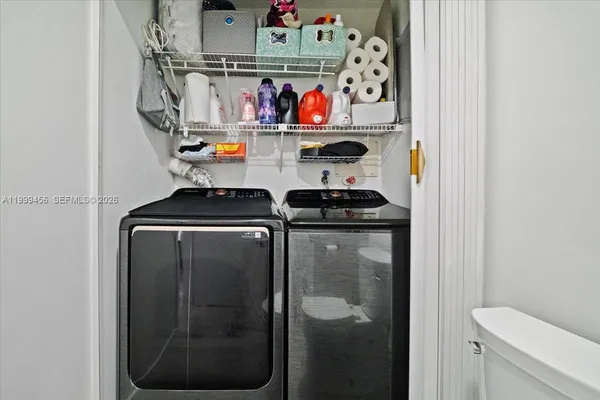 a bathroom with a toilet a sink and a mirror