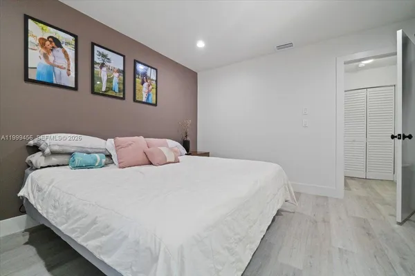 a bedroom with a bed and a desk in it