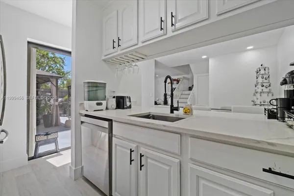 a kitchen with stainless steel appliances a sink and cabinets