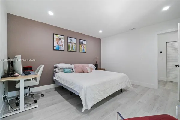 a bedroom with furniture and a flat screen tv