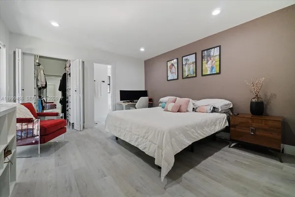 a bedroom with a bed and a flat screen tv