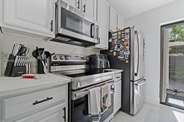 a kitchen with appliances cabinets and a counter top space