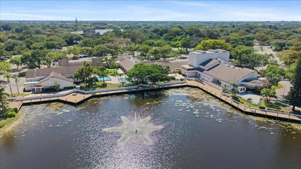 an aerial view of residential houses with outdoor space and river