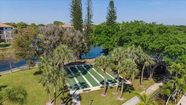 an aerial view of a house with a yard